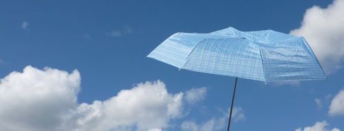 blue parasol on the blue sky background