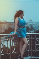 girl posing on the bridge in the town