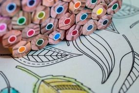 stack of colored pencils on a sheet of paper