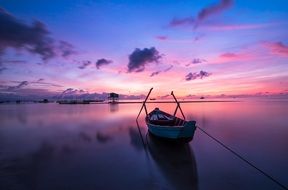 boat on the water near the island at sunset
