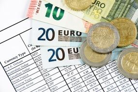 bills and coins are on a piece of paper
