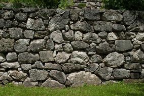 stone wall on green grass