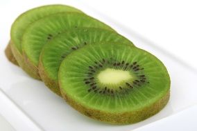 sliced kiwi on the white plate