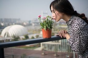 young asian woman sniffing flowers