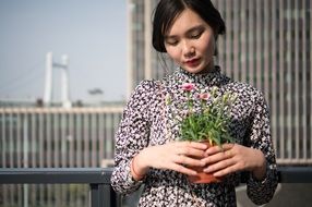 asian model with potted plant
