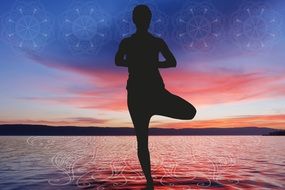 meditating female yogi at sunset