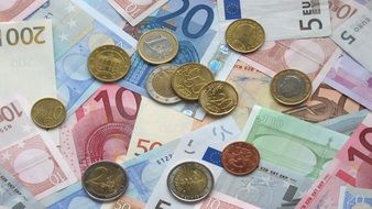 Euro notes and coins on the table as background