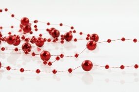 red beads on a thin thread