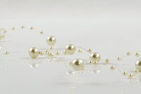 golden beads on a thin thread