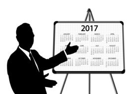 silhouette of a businessman showing a calendar