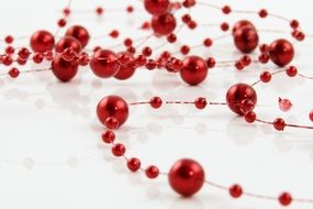 red beads on a thin red thread