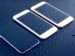 wet iPhones on the wet surface