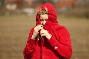young blond woman in red hoodie