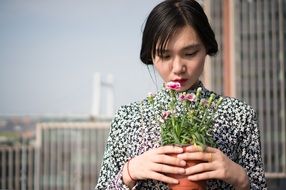 asian model posing with potted flowers