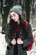beautiful young model posing in the winter forest