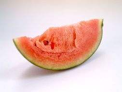 a slice of watermelon on a white surface