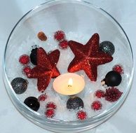 Christmas stars and balls on glass bowl
