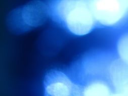 blue wallpaper with white bubbles in bokeh