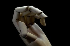 wooden hand on the black background