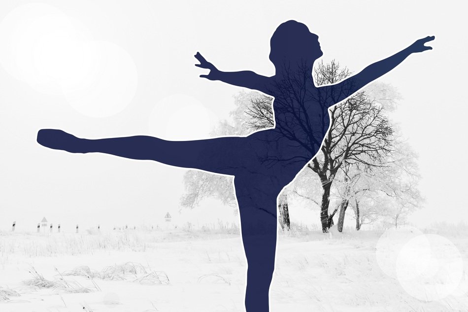 silhouette of a ballerina on the background of the winter landscape