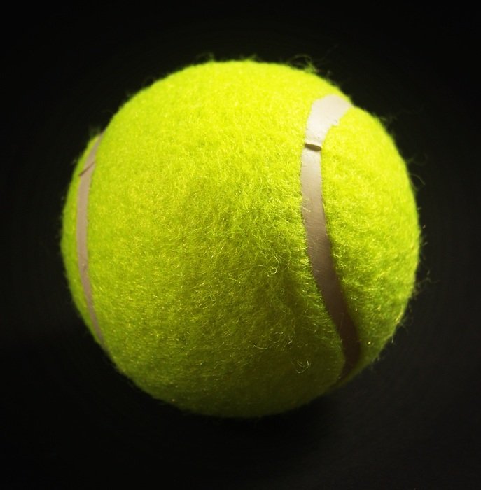 tennis ball on the black background