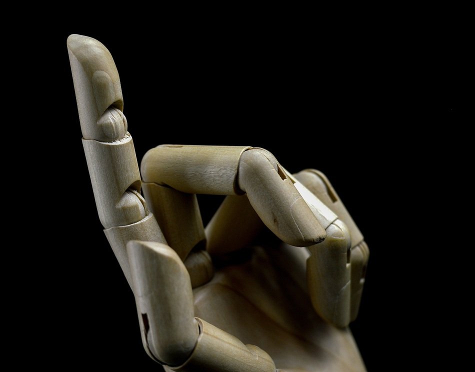 wooden hand with finger up