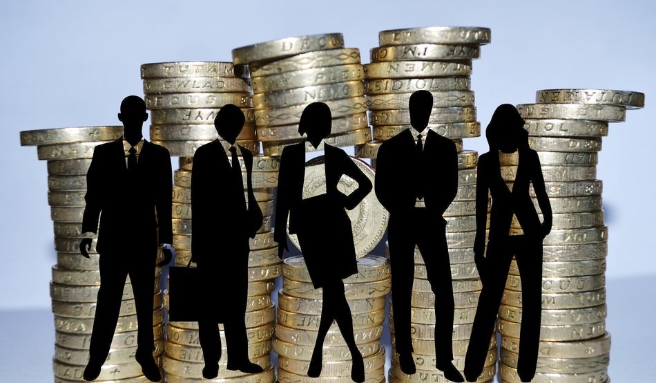 silhouette of people against the backdrop of the tower of coins