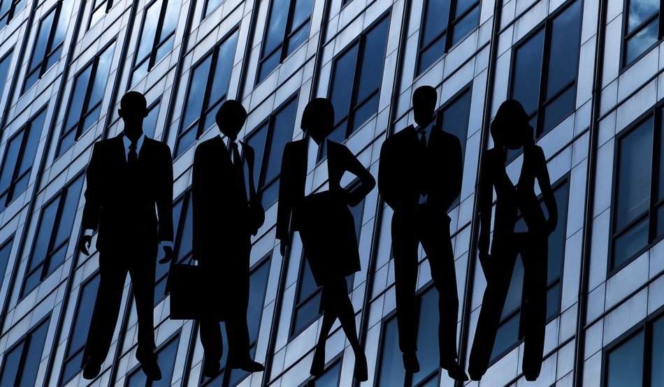 silhouette of people against the building