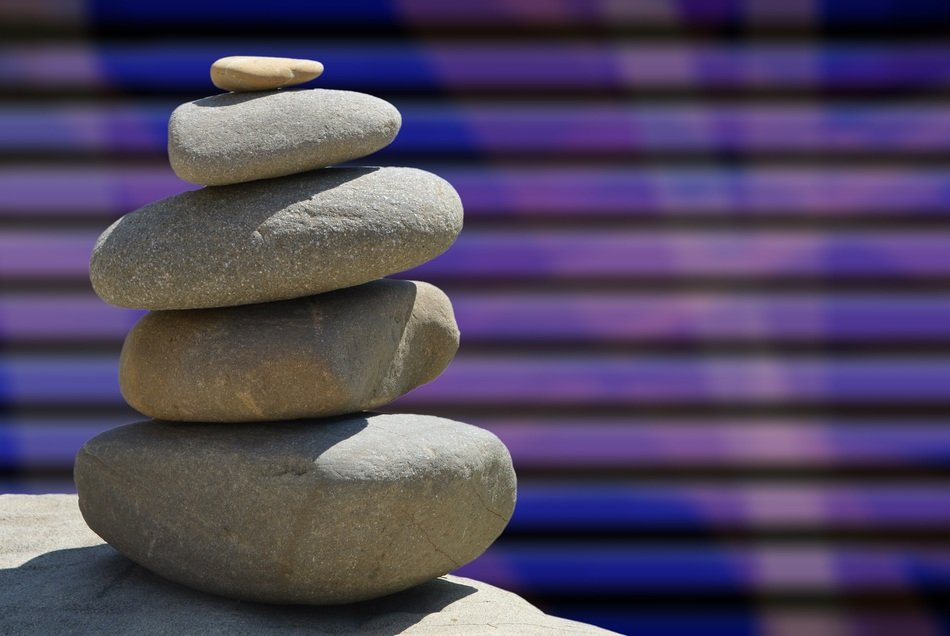 zen stones on the background of purple stripes
