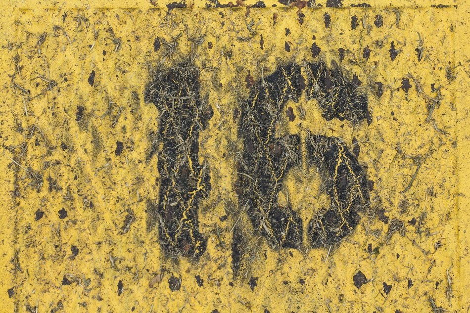 painted number 16 on the metal wall as background