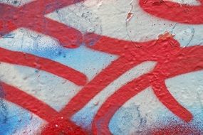 red graffiti on the weathered wall