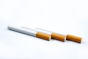 three isolated cigarettes