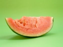 pink slice of watermelon on a green background