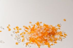 white and orange glass stones on a white background