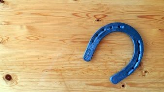blue horseshoe on the wooden surface