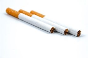 three isolated cigarettes on a white background
