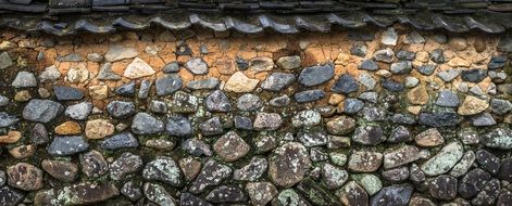 roof tile over stone wall