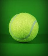 yellow tennis ball on the green background