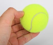 background with yellow tennis ball in human hand
