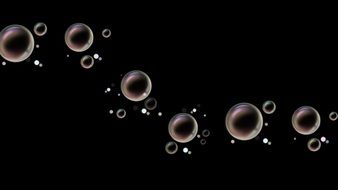 soap bubbles of different sizes on a black background