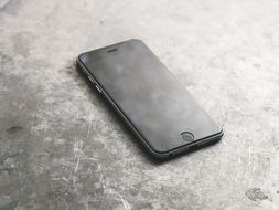 black iPhone on the metal surface