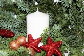 white Christmas candle and tree baubles