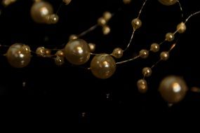 beads of gold color on a thin thread