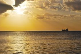 boat on the sea horizon at sunset