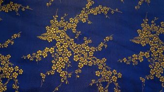 blue fabric with golden floral pattern