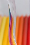 glass leg on the blurred colored pencils background