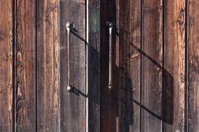 old wooden gate with iron handles