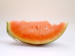 red watermelon slice on a white surface