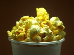 popcorn in a glass on a brown background