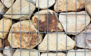 natural stone wall with metal fence